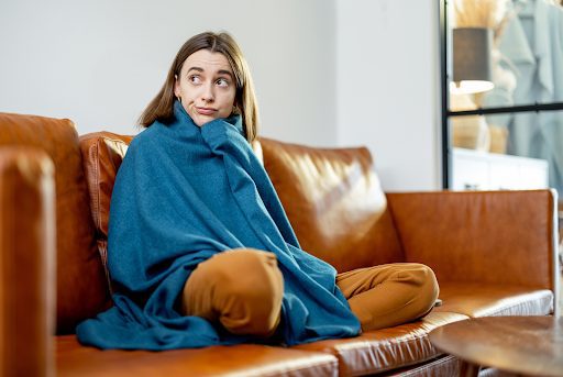 A woman sitting in a cold home in Farmers Branch, TX.